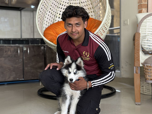 Incredipets trainer with a husky puppy during an in-home session